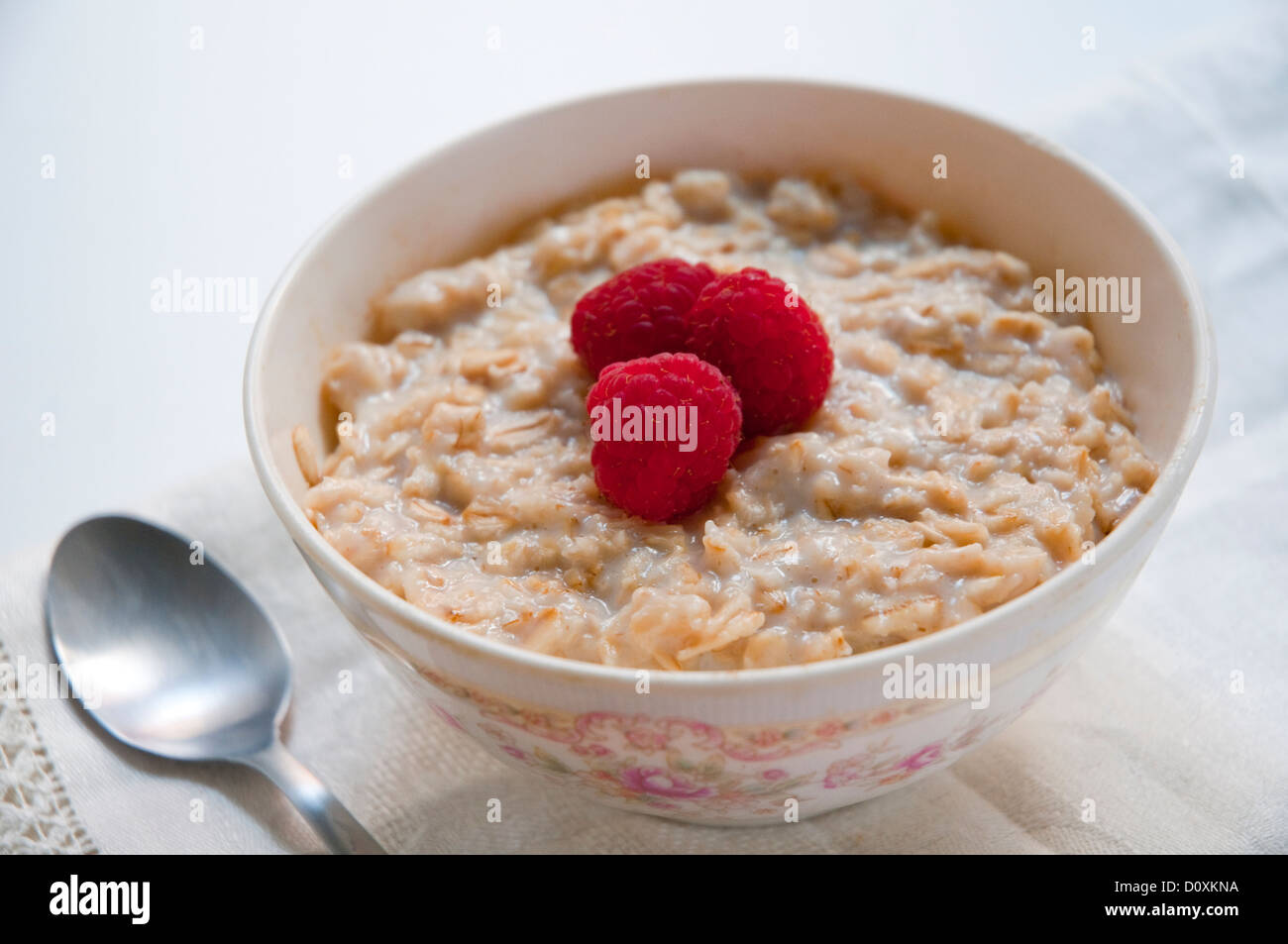Bowl of porridge with raspberries. Close view. Stock Photo