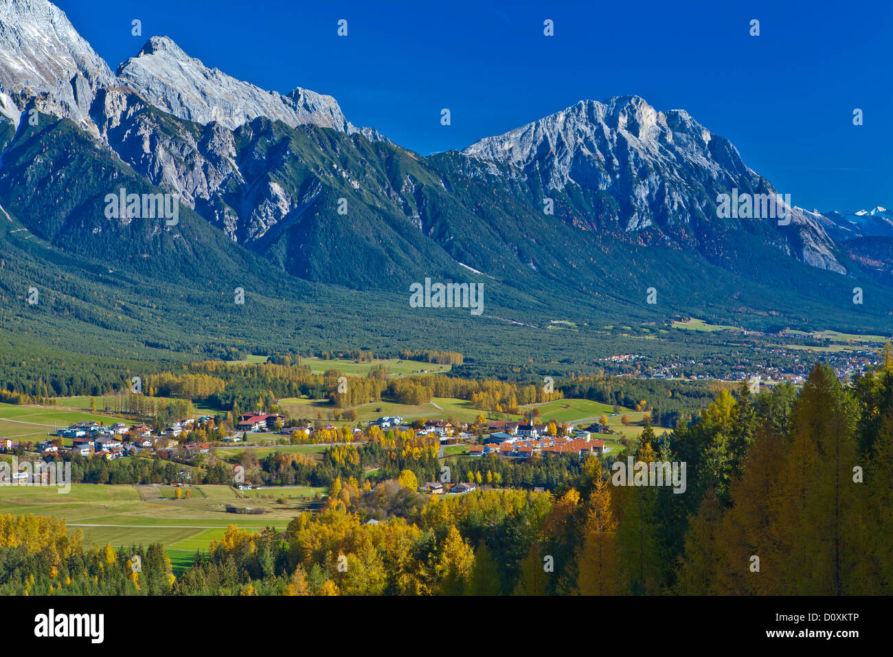 Austria Europe Tyrol Tirol Mieming chain plateau Obsteig place tourism place autumn larches Yellow blue mountains Stock Photo