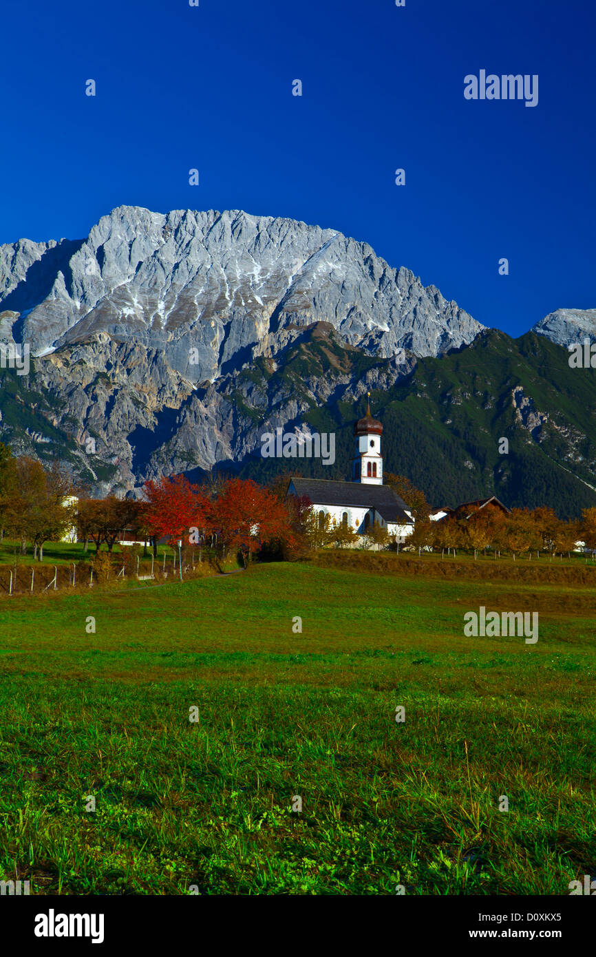 Austria Europe Tyrol Tirol Mieming chain plateau Mieming Saint Georg mountains Hochplattig meadow cherry trees Red Stock Photo