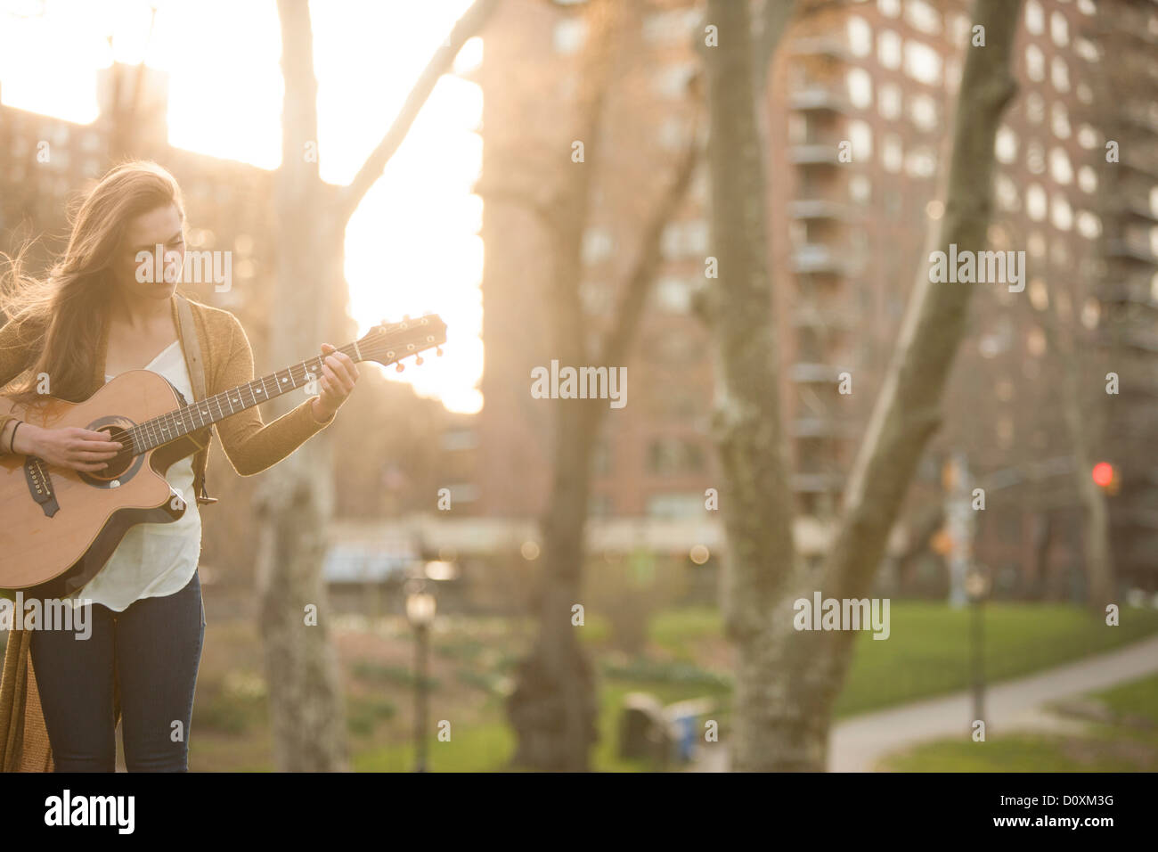 Young woman playing guitar in the park Stock Photo - Alamy