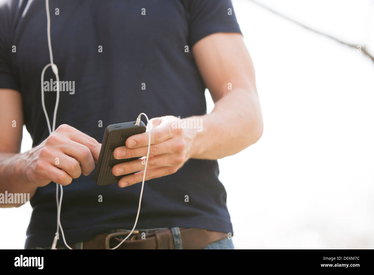 Young man with smartphone and earphones Stock Photo