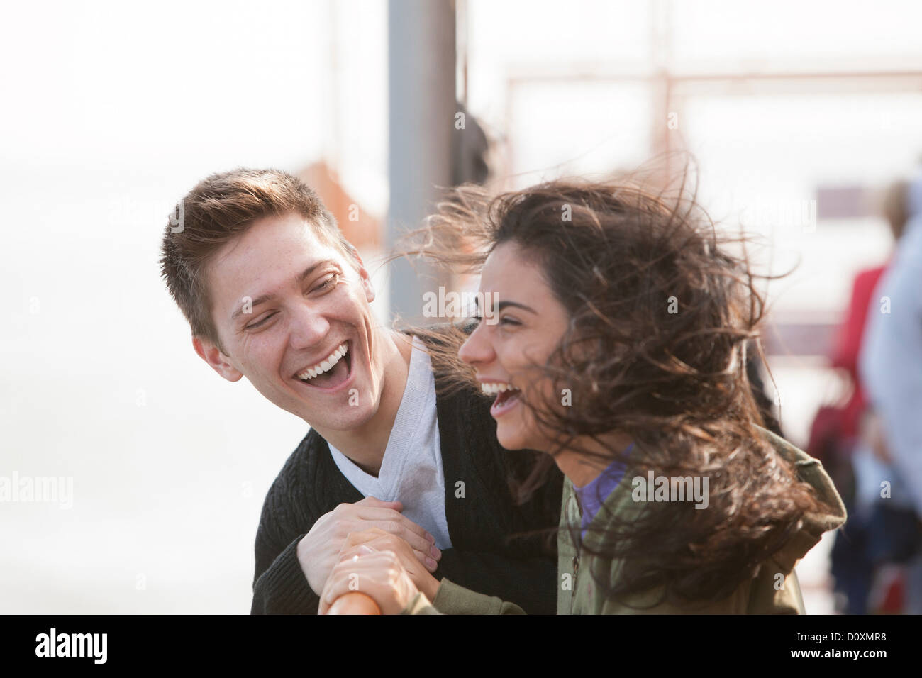 Young couple on ferry, laughing Stock Photo