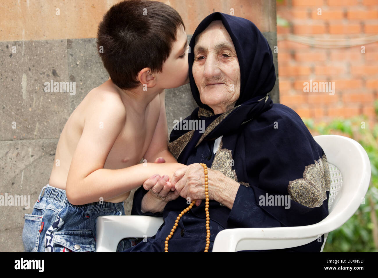 Secrets between kid and granny Stock Photo