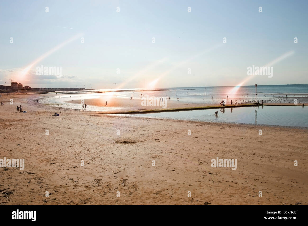 Beach scene with rays of light, Margate, Kent, UK Stock Photo