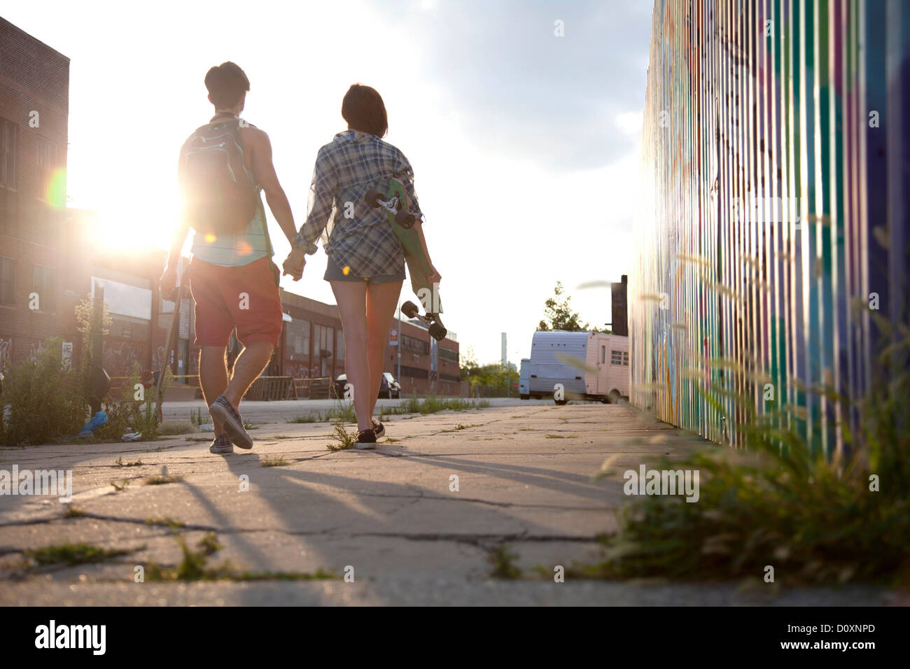 Young couple walking holding hands, rear view Stock Photo - Alamy