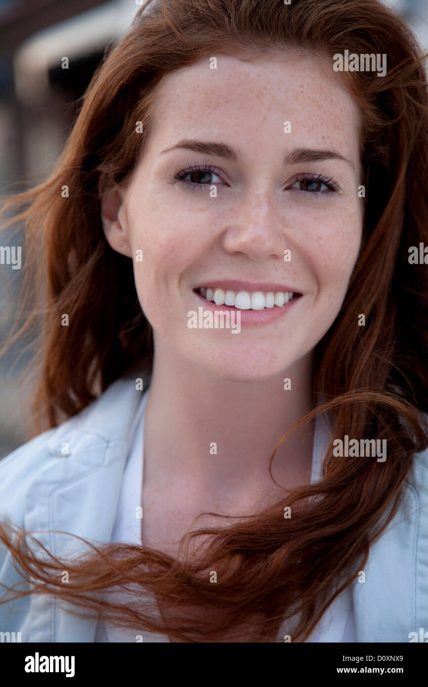 Young woman with long red hair, portrait Stock Photo - Alamy
