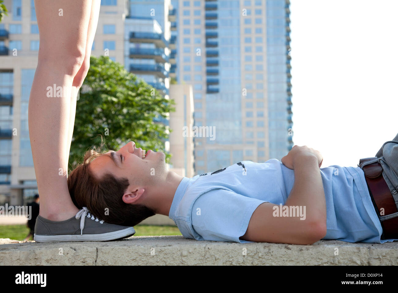 Young couple on wall, woman standing above man Stock Photo - Alamy