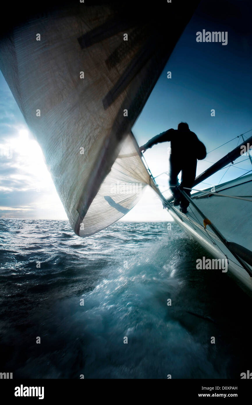 Silhouette of man on sailing boat Stock Photo - Alamy