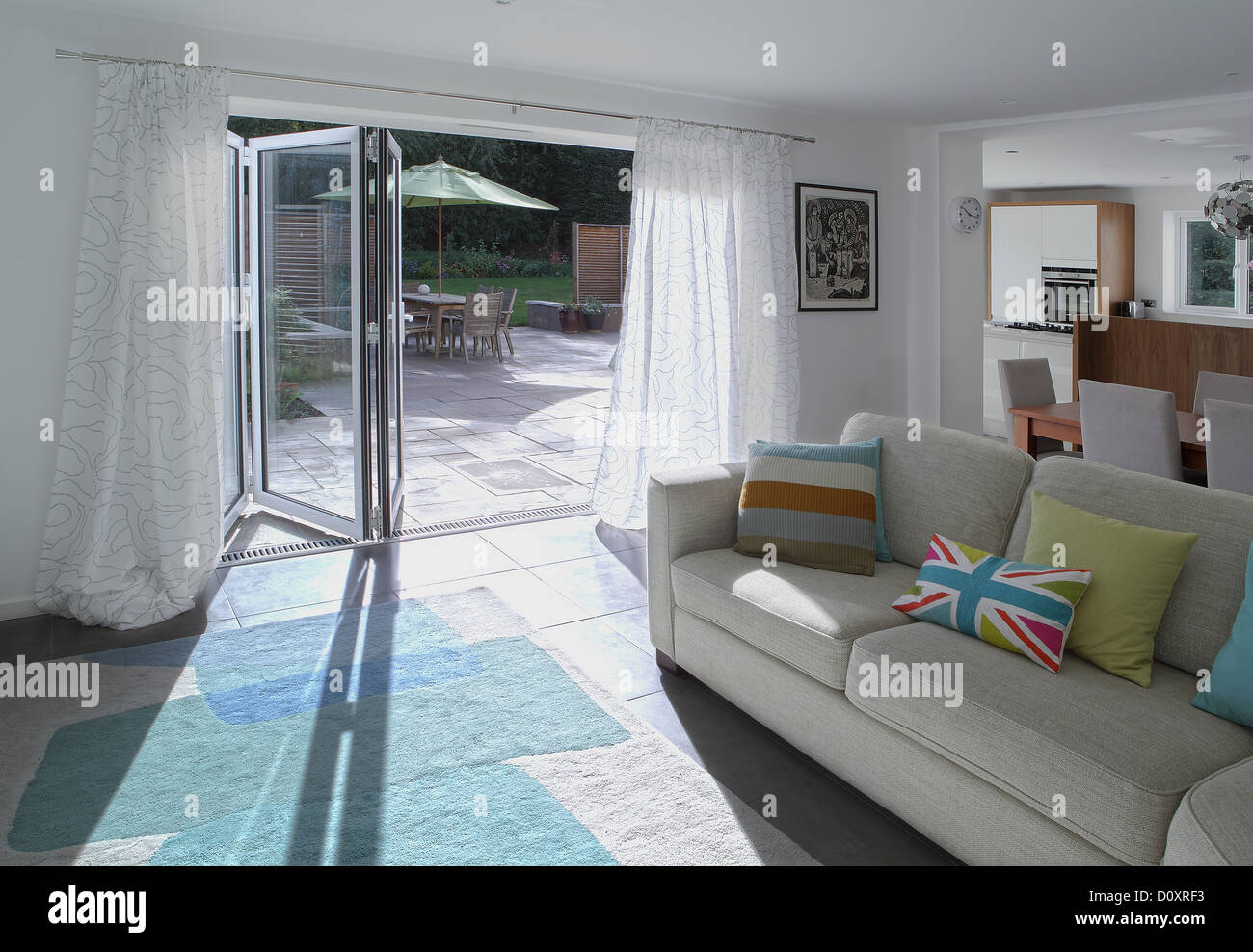 Open plan living area with open patio doors Stock Photo Alamy