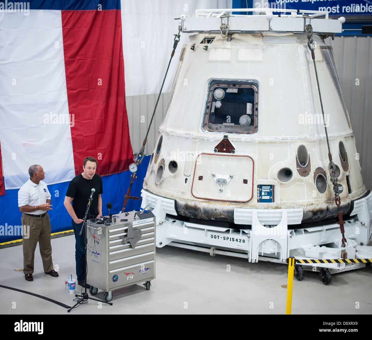 NASA Administrator Charles Bolden, left and SpaceX CEO and Chief Designer Elon Musk in front of the historic Dragon capsule that returned to Earth on May 31, 2012 following the first successful mission by a private company to carry supplies to the International Space Station June 13, 2012 at the SpaceX facility in McGregor, Texas. Stock Photo