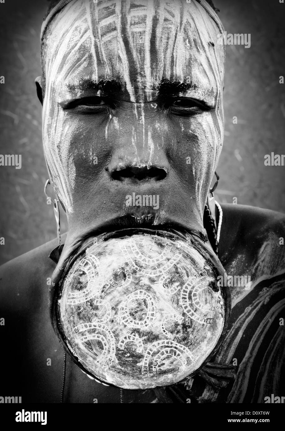 Black And White Portrait Of A Mursi Tribe Woman With Lip Plate And Enlarged Ears In Mago National Park, Omo Valley, Ethiopia Stock Photo