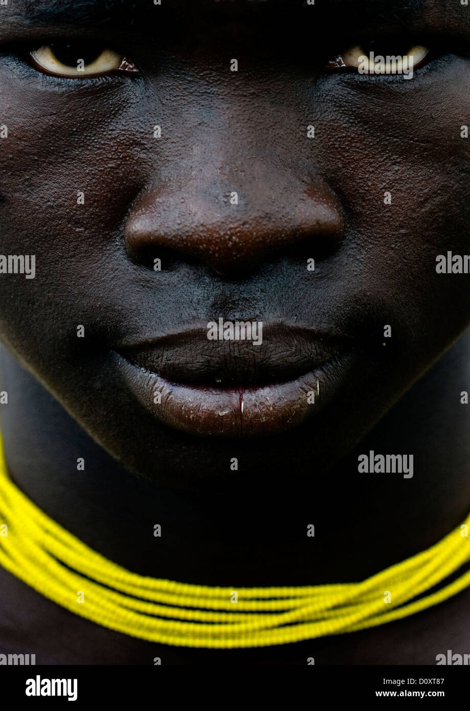 Close Up On The Face Of A Mursi Tribe Man With Yellow Necklace, Omo Valley, Ethiopia Stock Photo