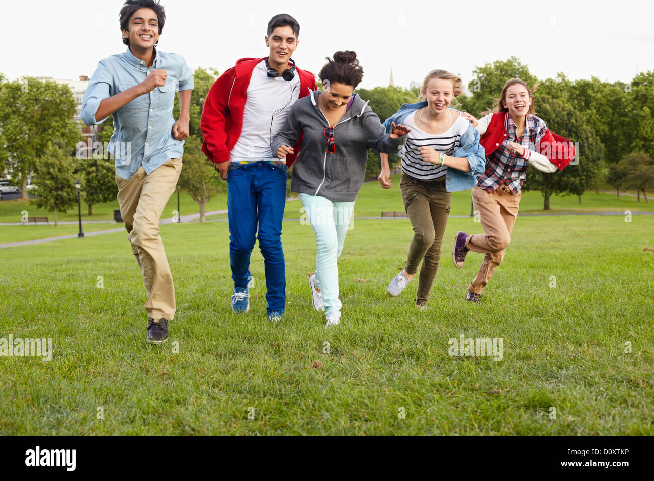 Teenagers running in a park Stock Photo