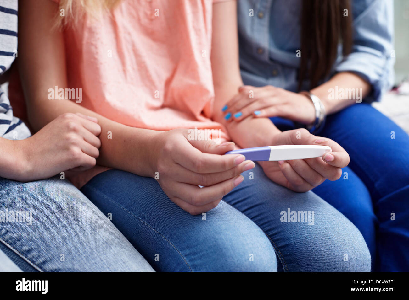 Teenage girls with pregnancy test Stock Photo