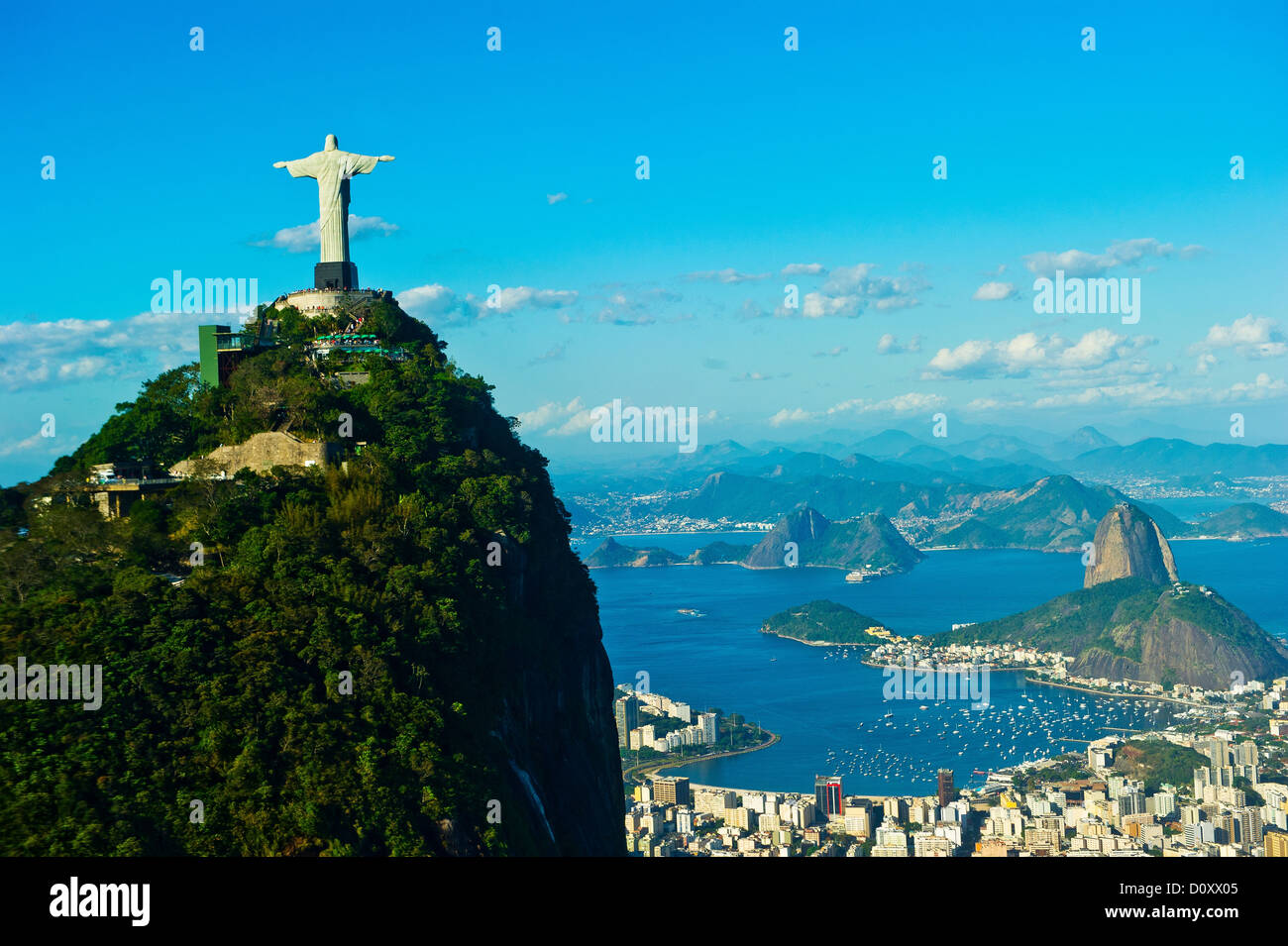 Christ the Redeemer statue overlooking Rio de Janeiro and Sugarloaf Mountain, Brazil Stock Photo