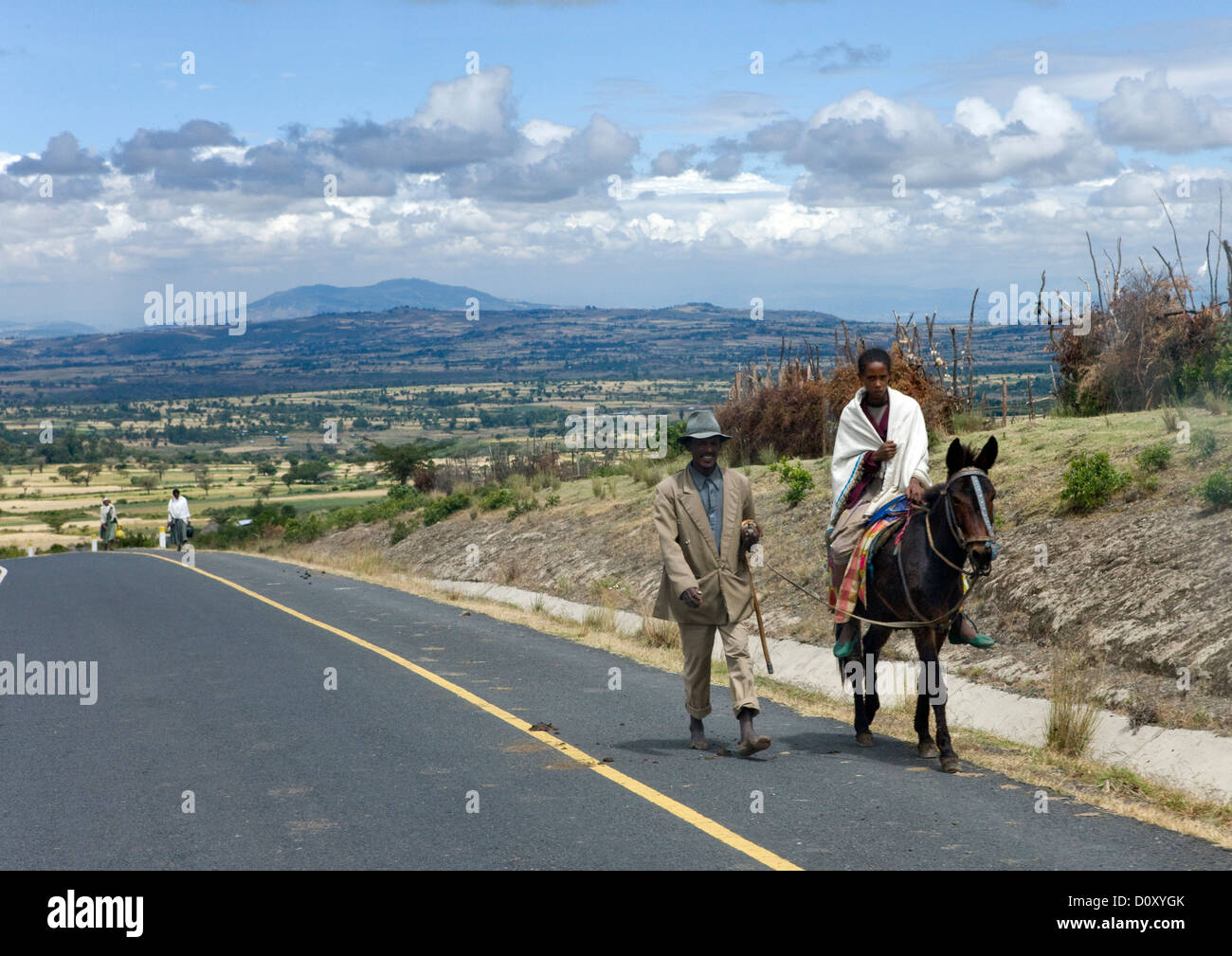 Man Riding A Horse On A Brand New Highway, Konso, Ethiopia Stock Photo