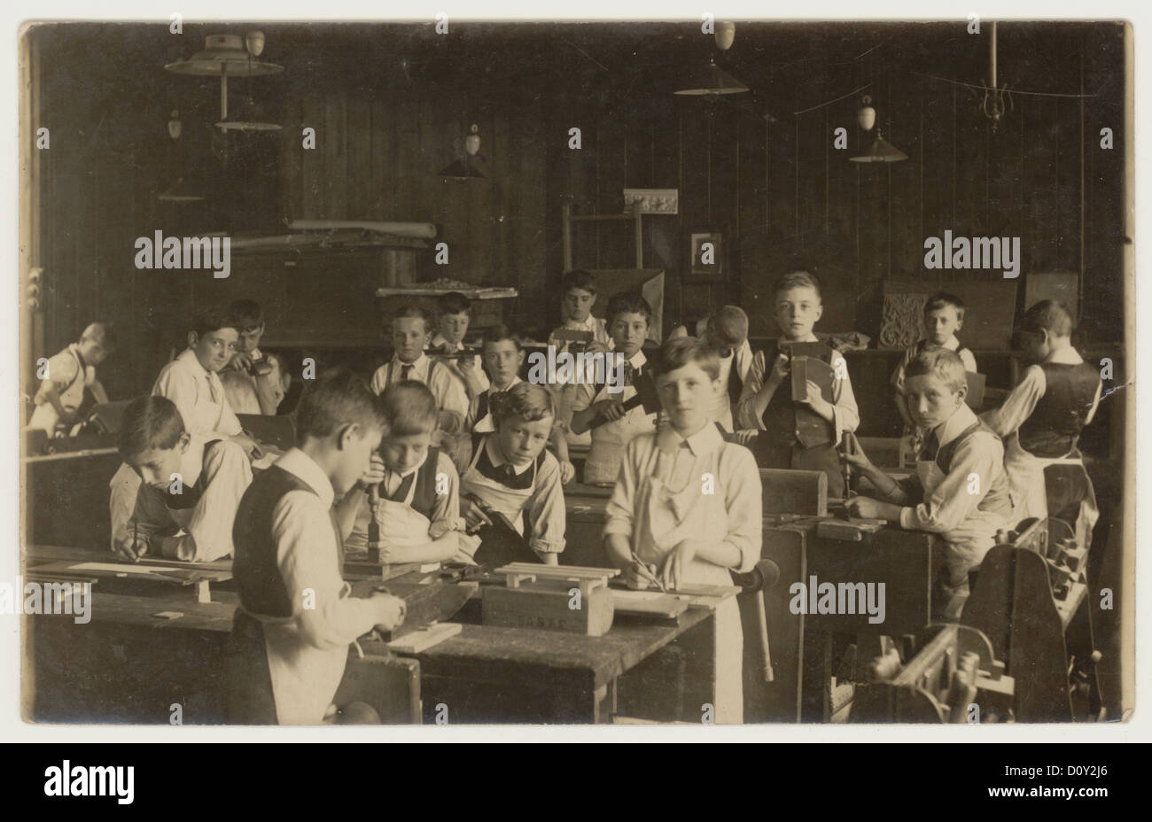 Original early 1900's Victorian or Edwardian photograph of junior boys at a woodwork class, from studio of  Montague Cooper, Somerset, England, UK  circa 1910 Stock Photo