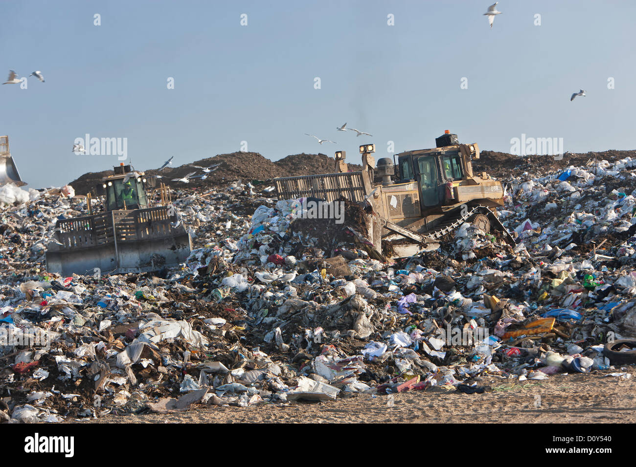 Tractor compactor/dozer 'track laying' pushing trash at landfill, California. Stock Photo