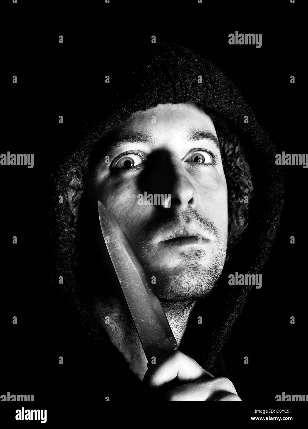 robber with a knife about to commit a crime Stock Photo