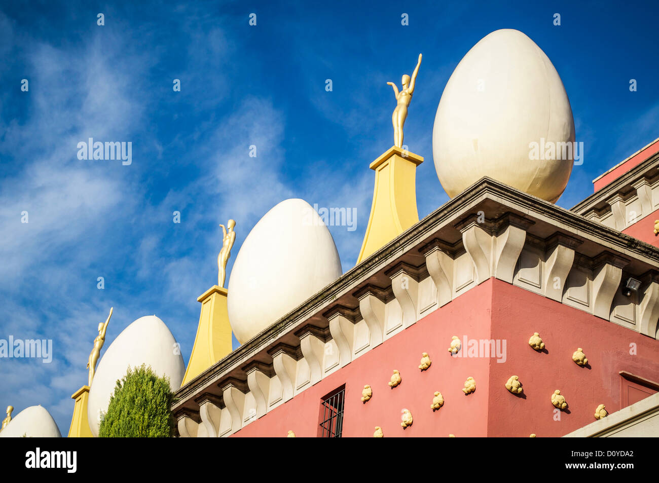 Huge decorative egg shapes alternate with golden statues on pedestals atop the Salvador Dali Museum in Figueres, Spain. Stock Photo