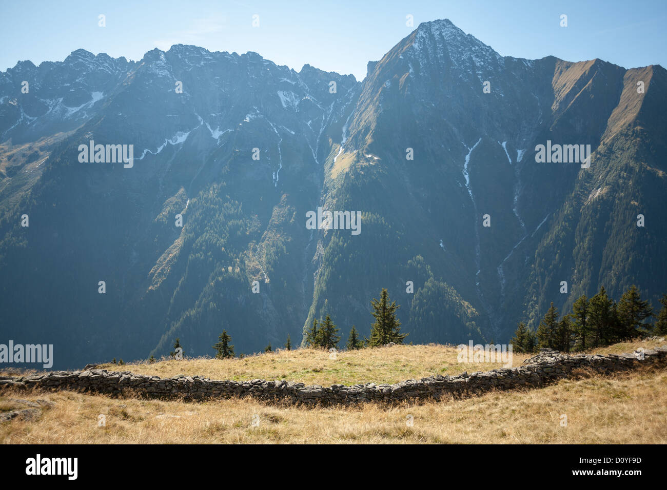 Old rough stone wall running along grassy mountain plateau at Ahorn in ...