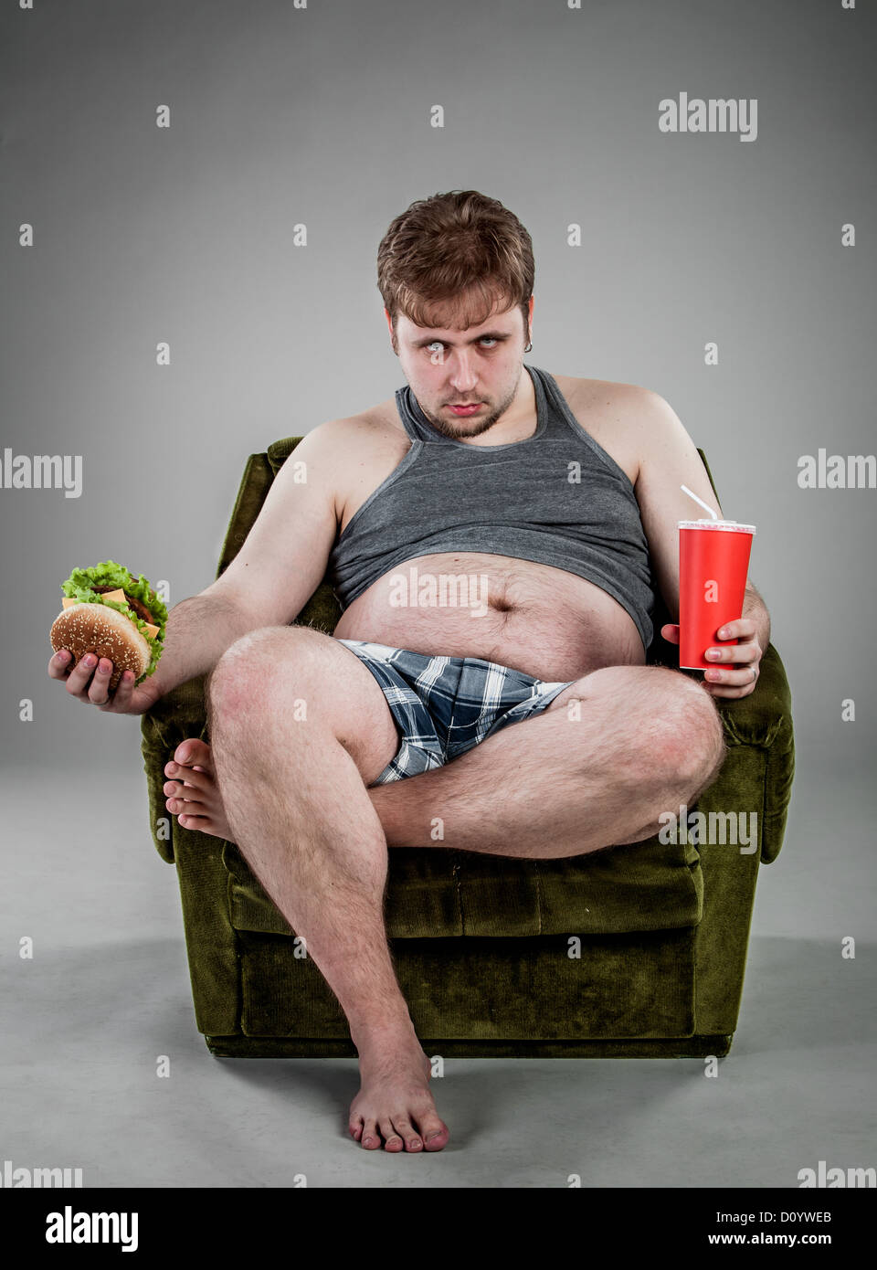 fat man eating hamburger Stock Photo