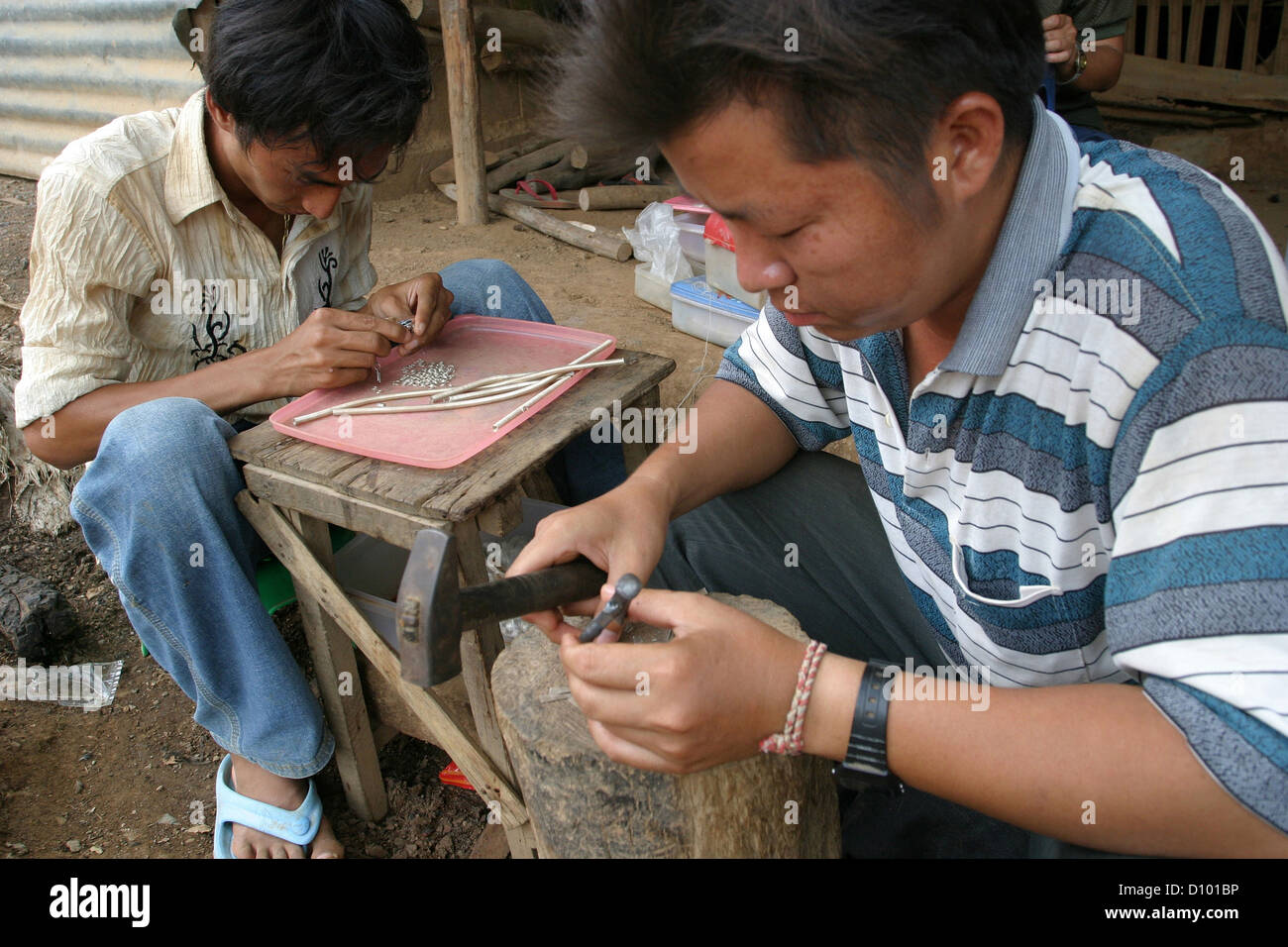 Silver smith inside Hmong refugee camp in Saraburi, Thailand. Stock Photo