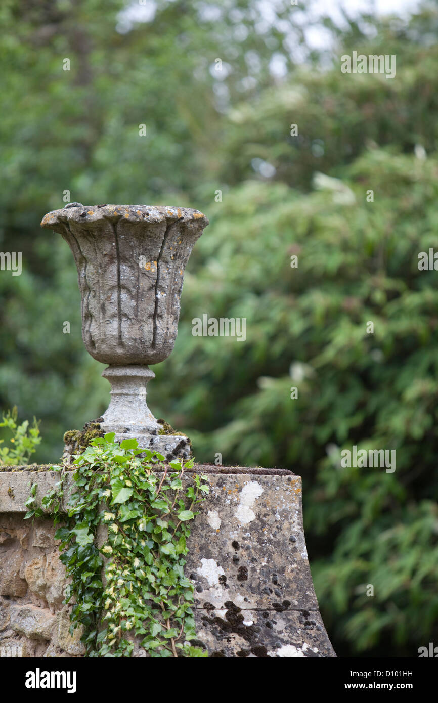 Antique stone plant urn on garden wall, Gloucestershire, England, UK Stock Photo