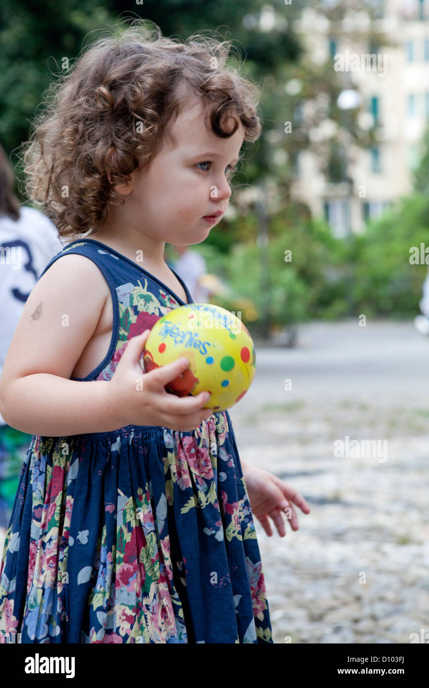 Little girl holding small ball Stock Photo Alamy