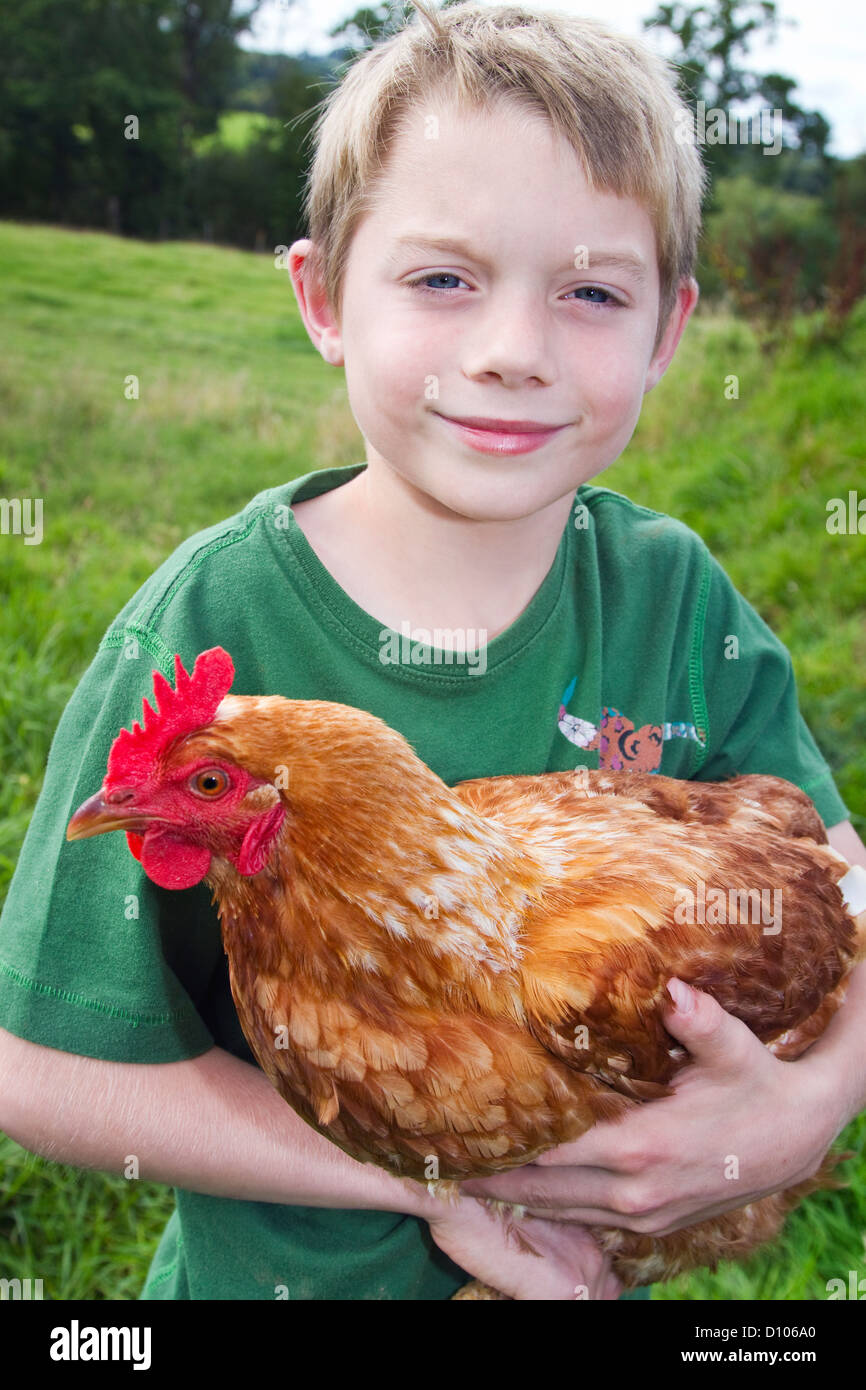 Little boy holding a chicken Stock Photo