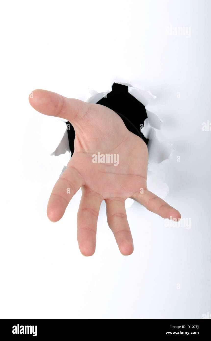 Hand Through Object Hand through the hole in paper Stock Photo - Alamy
