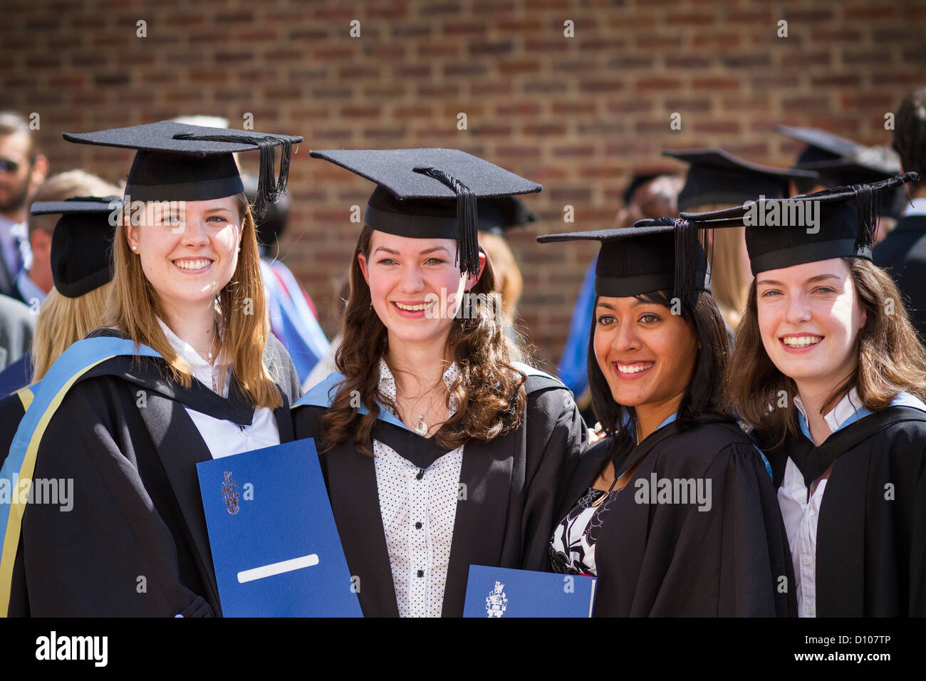 Four girls proudly present their degree certificates after graduating from the Engineering School of Southampton University. Stock Photo