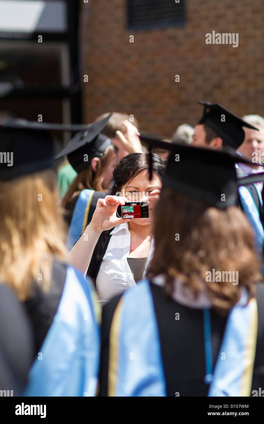 Girl photographs graduates from the Engineering School of the University of Southampton, England. Stock Photo