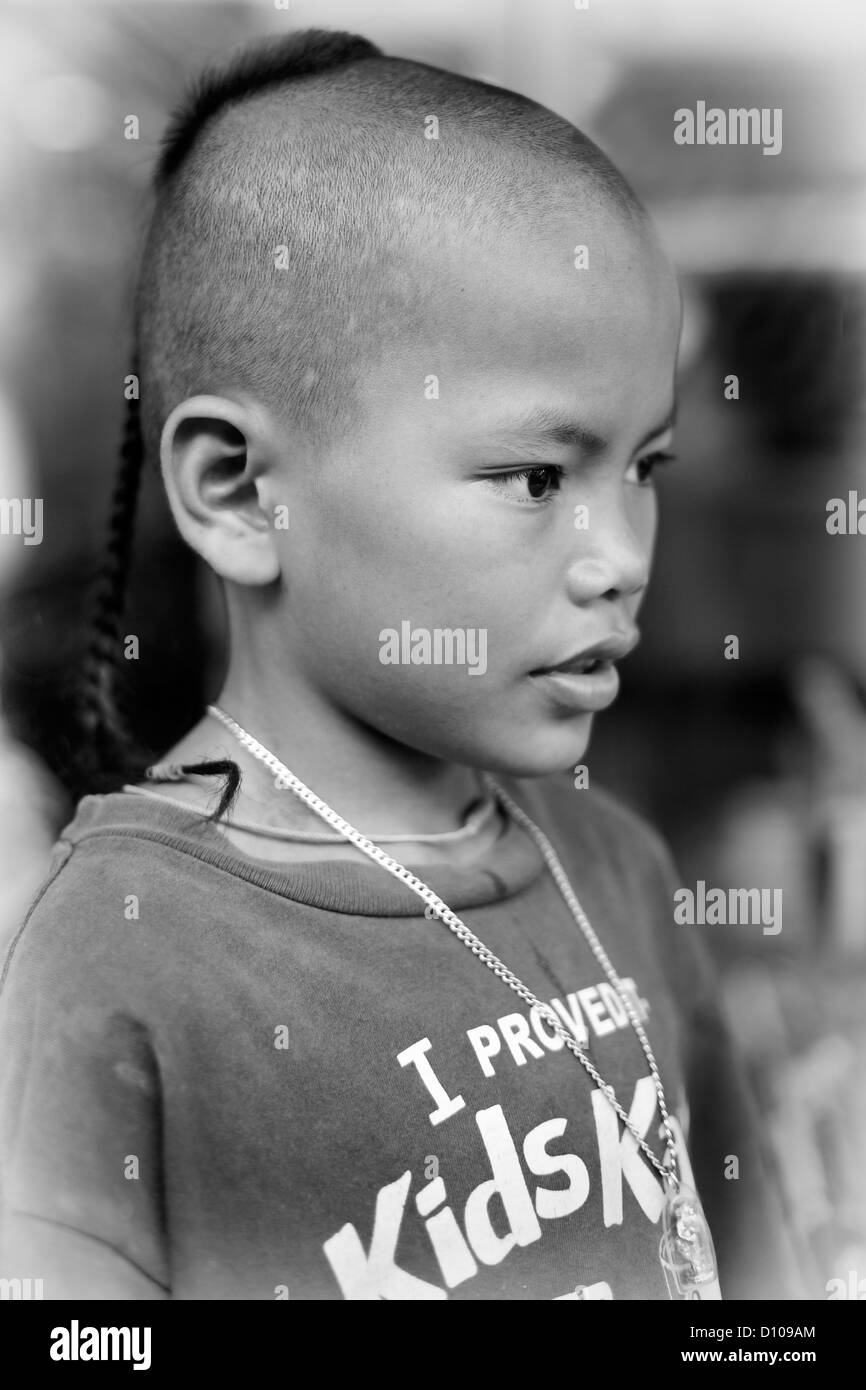 Traditional top knot shaven head hairstyle on a Thai young boy. Thailand  Southeast Asia Black and white photography Stock Photo - Alamy