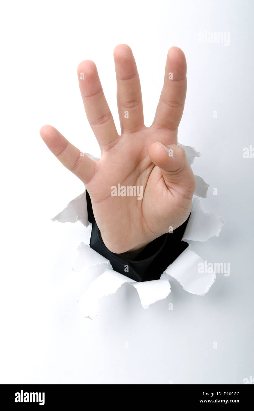 Hand through the hole in paper Stock Photo - Alamy