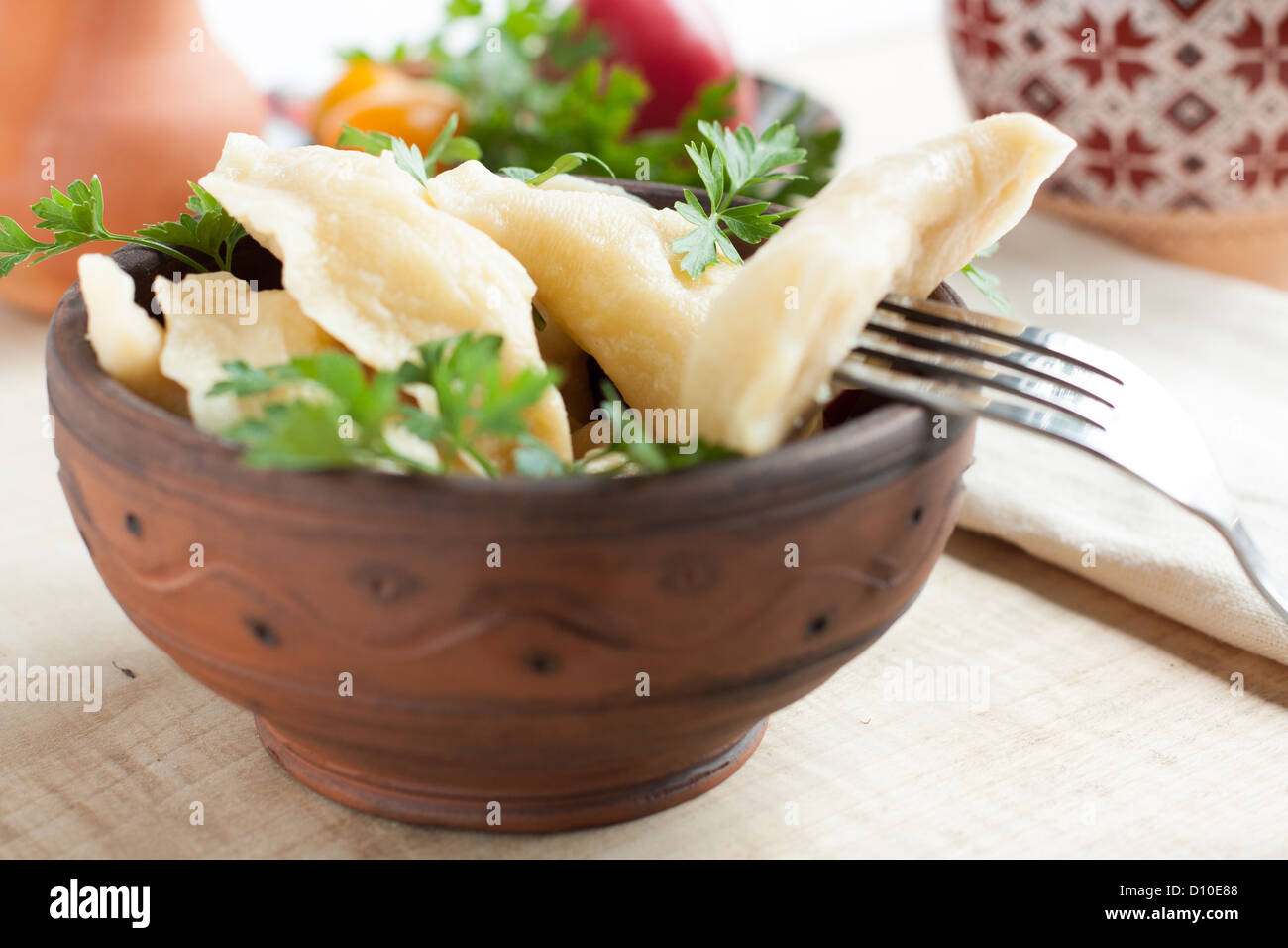 delicious Ukrainian dumplings in earthenware bowl, close up Stock Photo