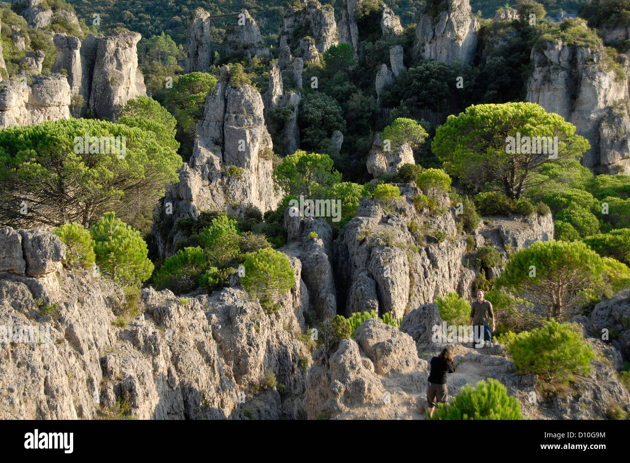 Dolomite rock columns, standing rocks because of erosion, people, Cirque de Moureze, Languedoc-Roussillon, France, Europe Stock Photo