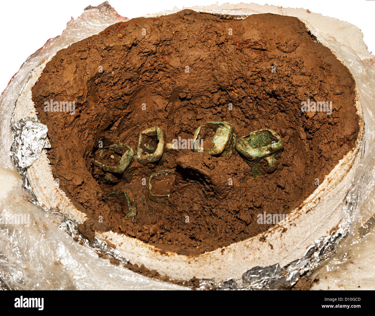 Bronze age ax heads in mud as collected following discovery in October