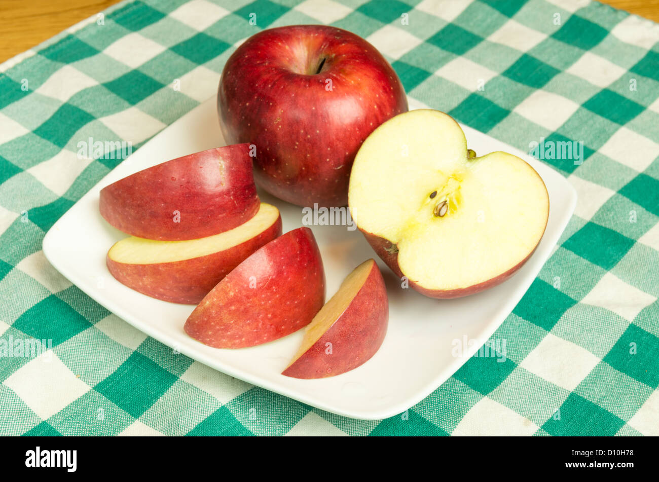 Winesap apple sliced on white plate Stock Photo Alamy