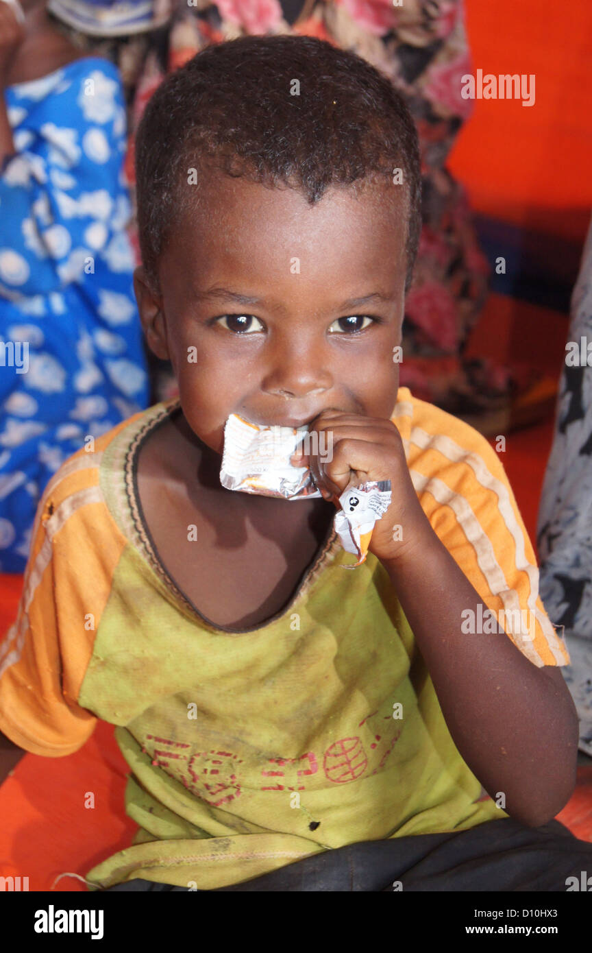 Somalian child eats from a package of vitamine rich food supplement in the refugee camp of Buramino, which is part of the wider refugee camp in Dolo Ado, Ethiopia, 21 November 2012. It has been one year since the hunger crisis on the Horn of Africa shocked the world in 2011. Many Somalians took refuge in Ethiopia at the time. Photo: Carola Frentzen Stock Photo