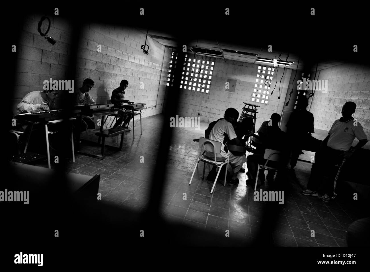 Members of the Mara Salvatrucha gang (MS-13) play music during the resocialization classes in the prison in El Salvador. Stock Photo