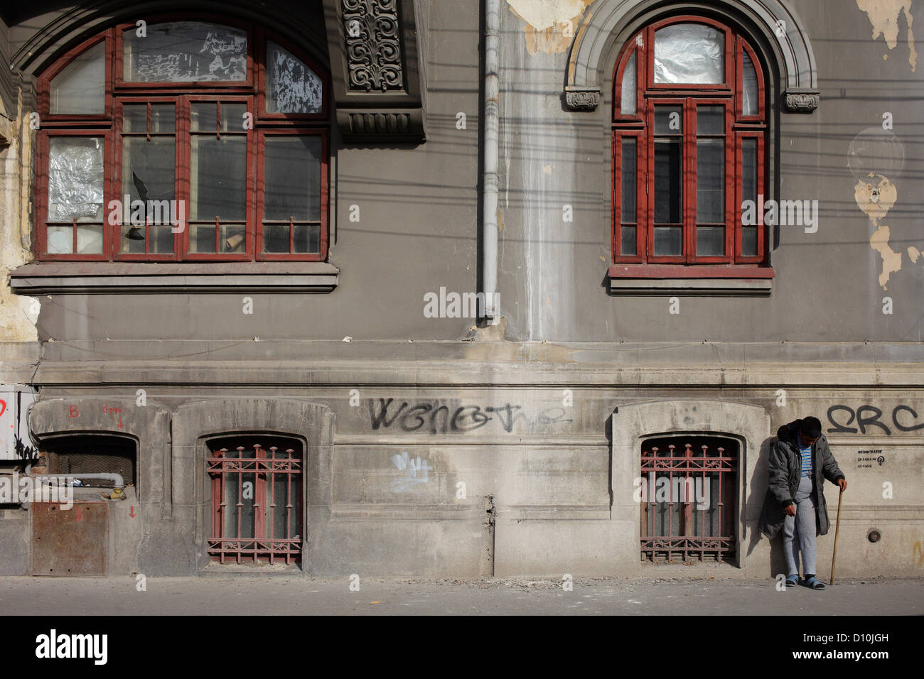 Bucharest, Romania, a man leans against an old building Stock Photo