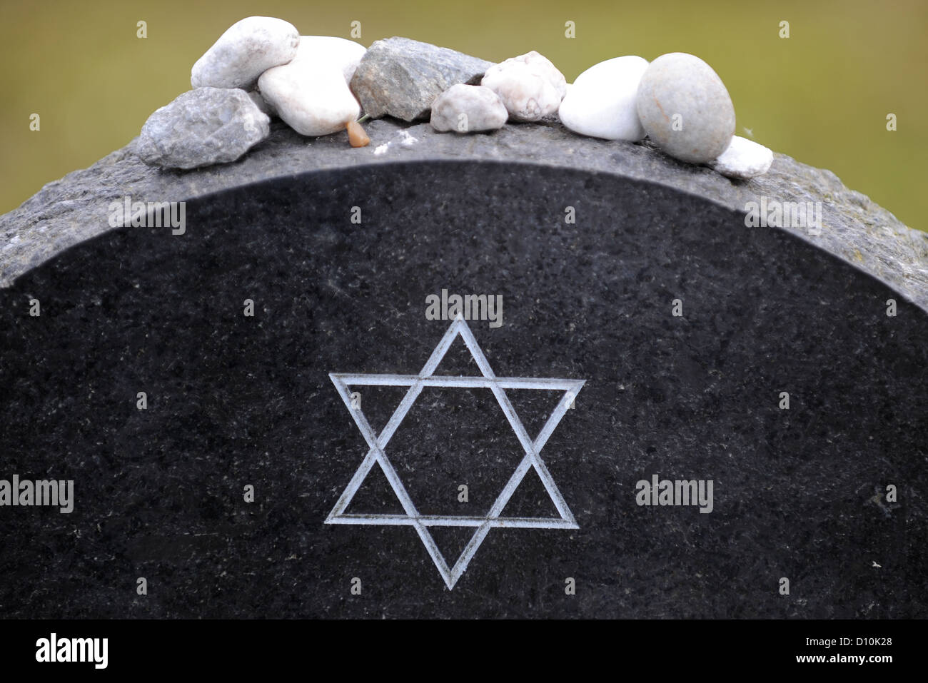 (dpa FILE) - An archive picture, dated 12 June 2009, shows the Star of David engraved on the tomb stone of Anne Frank at the Bergen-Belsen memorial site near Lohheide, Germany. The lack of public awareness in Germany concerning the crimes committed by the Nazi regime was common at the time when the former Bergen-Belsen concentration camp was founded as a memorial site 60 years ago. Since then, more than eight million people have visited the site where more than 70 000 prisoners of war and concentration camp prisoners where murdered. Photo: Peter Steffen Stock Photo