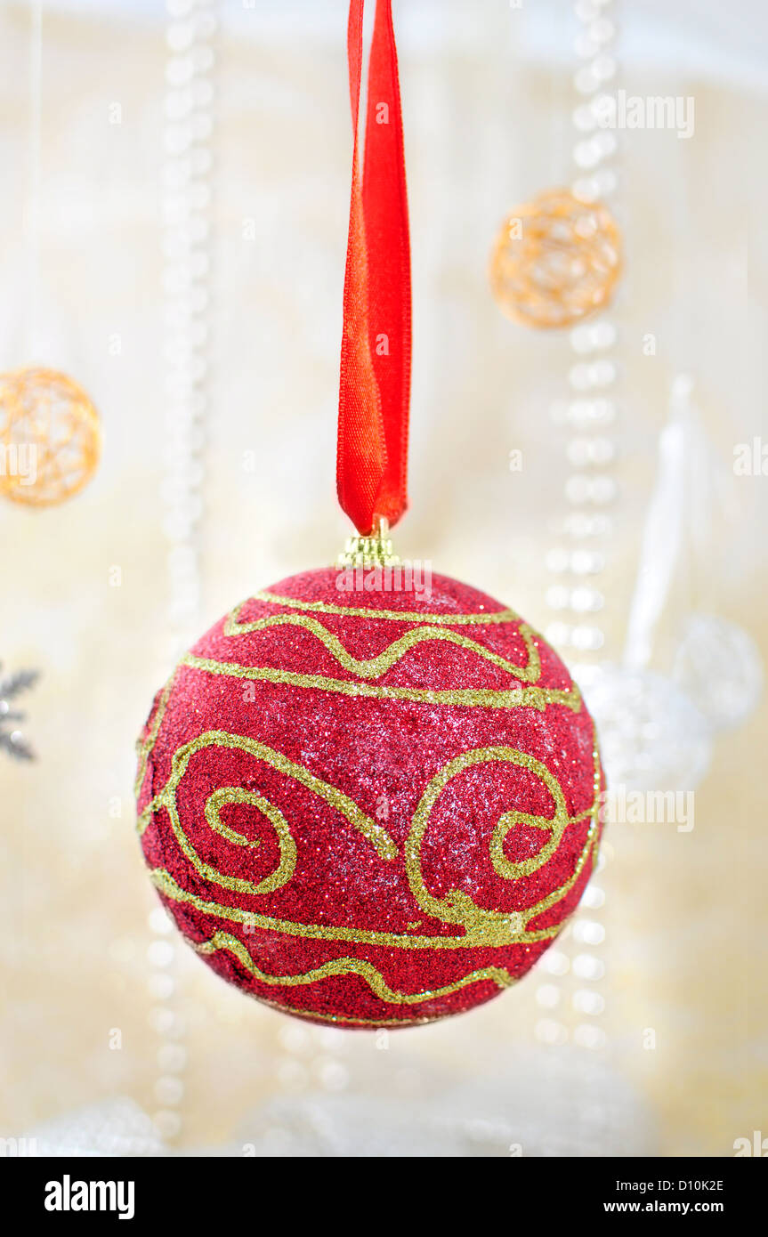 Red and gold christmas bauble on red ribbon Stock Photo
