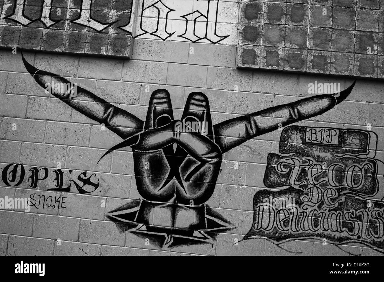 A Mara Salvatrucha gang graffiti (“Devil's horns”) painted on the wall of the prison in Tonacatepeque, El Salvador. Stock Photo