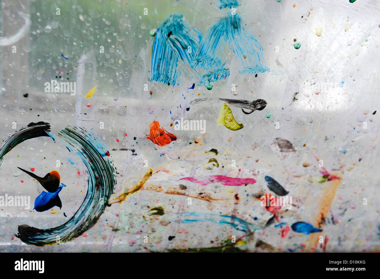 Paint spatters and brush marks on the window pane of an artists' studio