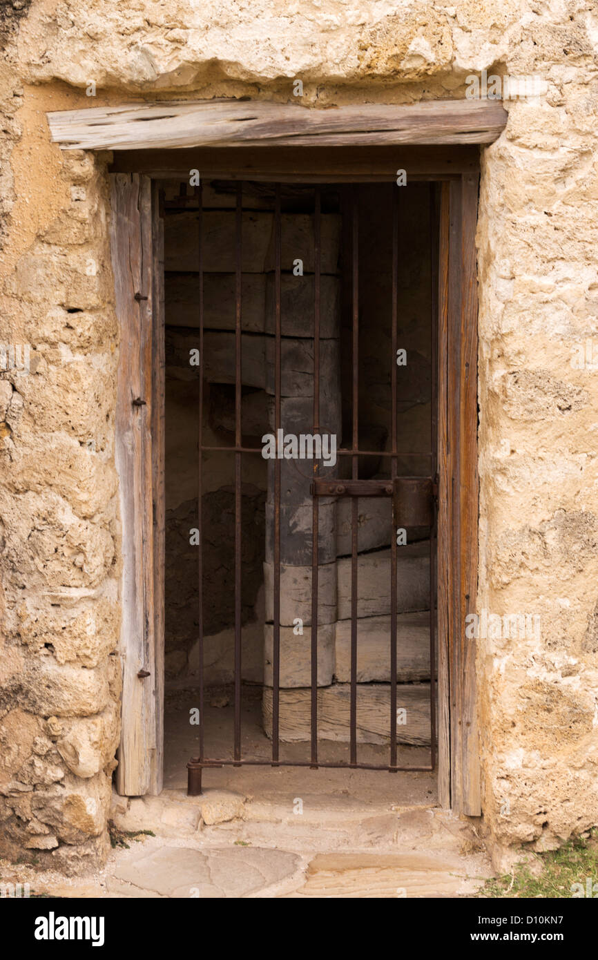 Doorway and locked iron gate that leads to a spiral stairway, which ascends the bell tower at Mission San Jose Stock Photo