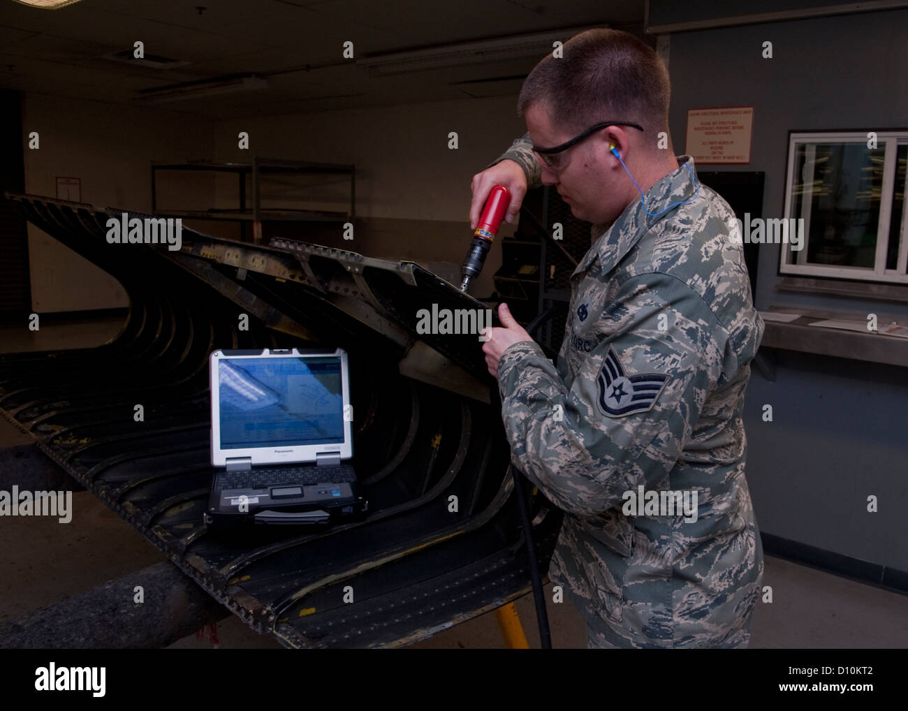 U.S. Air Force Staff Sgt. James B. Smith, aircraft maintenance craftsman of 1st Special Operations Equipment Maintenance Squadron repairs a damaged aircraft wing leading edge in the Eason Hangar at Hurlburt Field, Fla. Nov. 27, 2012. The leading edge is l Stock Photo
