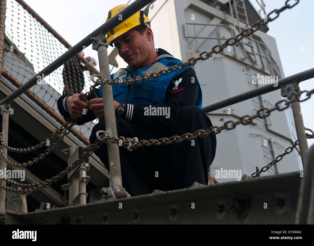 Boatswain's Mate 3rd Class Nate Peike prepares the brow of amphibious dock landing ship USS Fort