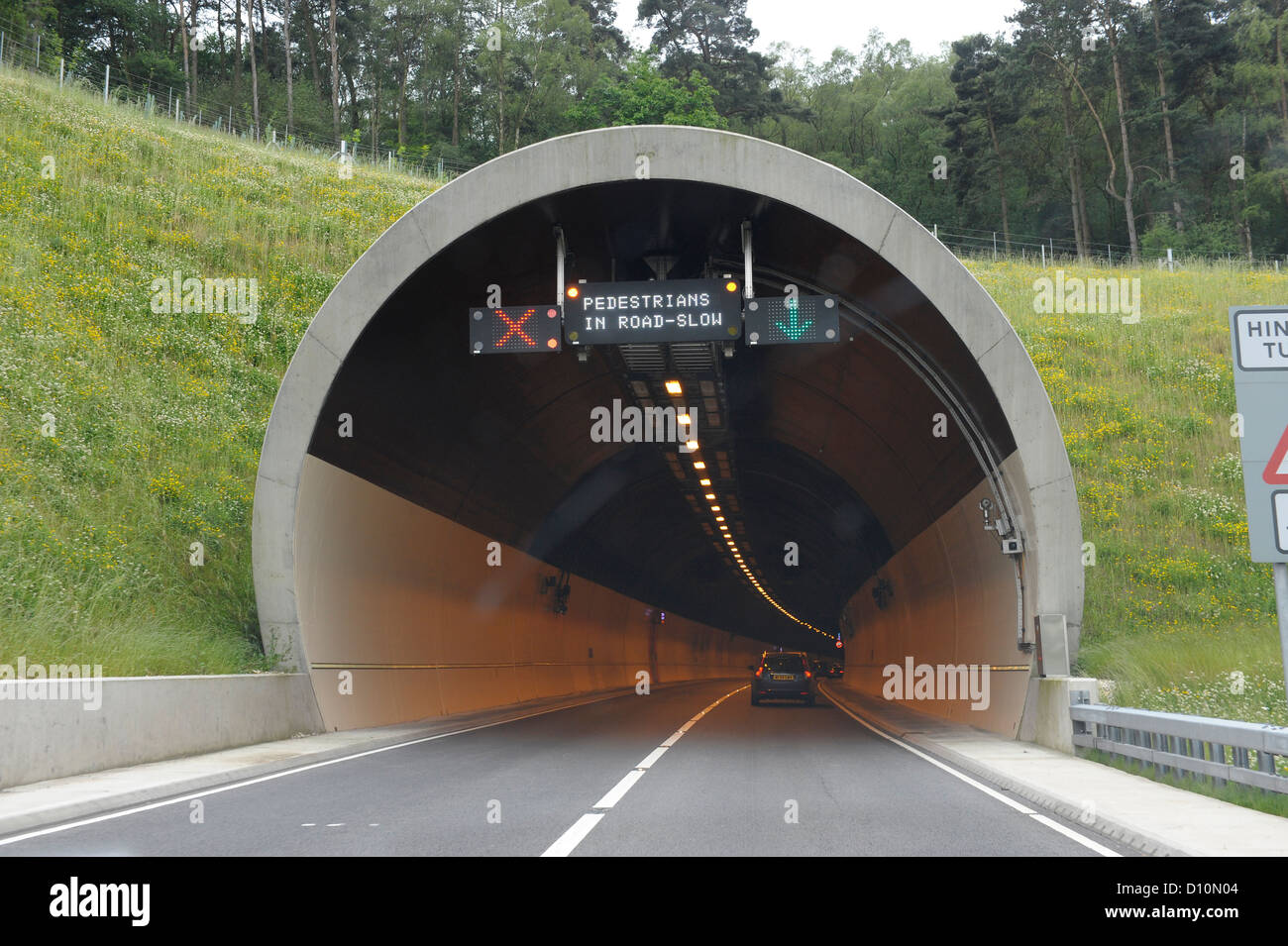 North portal of Hindhead Tunnel on the A3 in Surrey,displaying warning signs for single lane closure Stock Photo